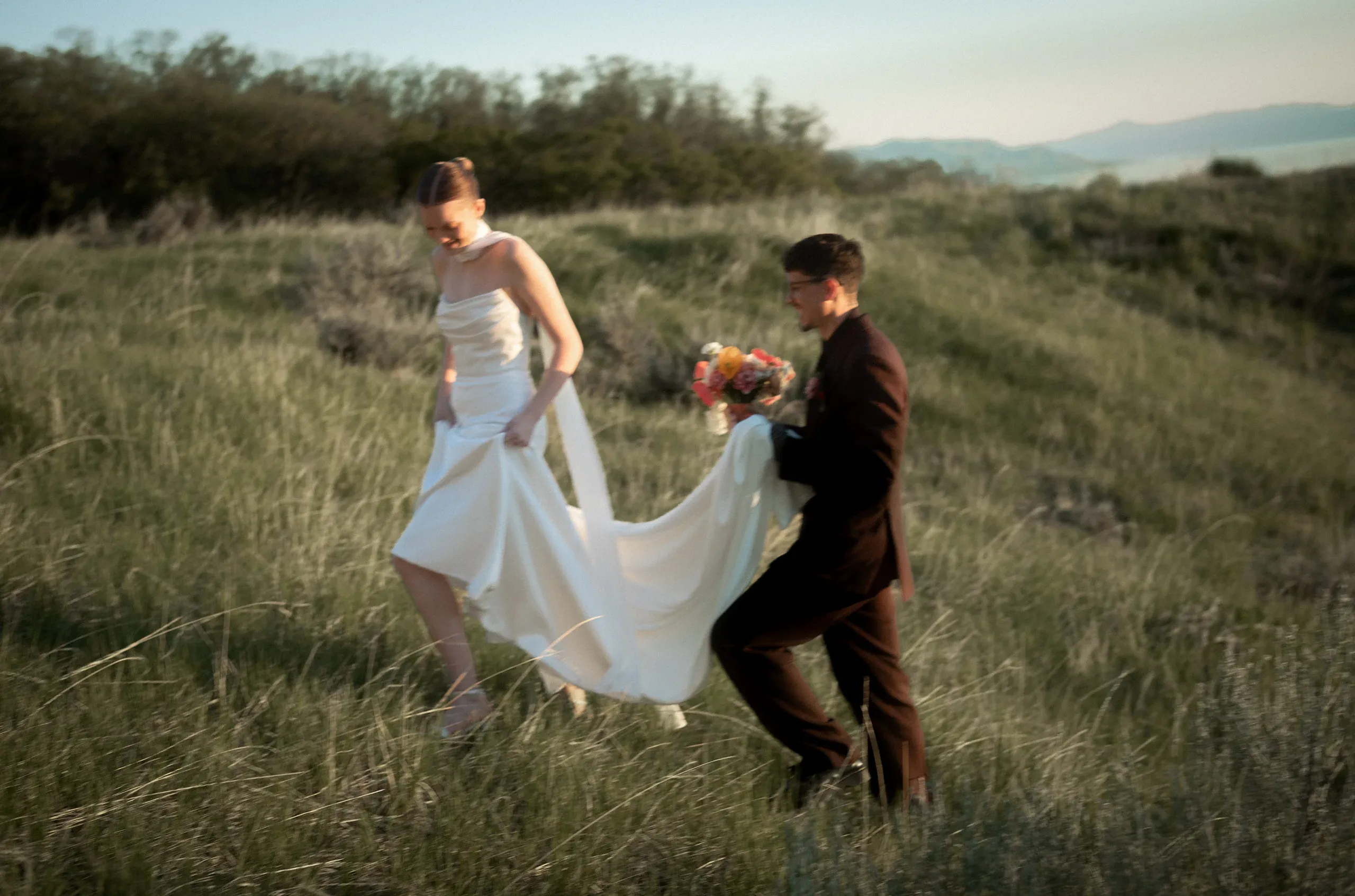 A couple walking through a grassy field